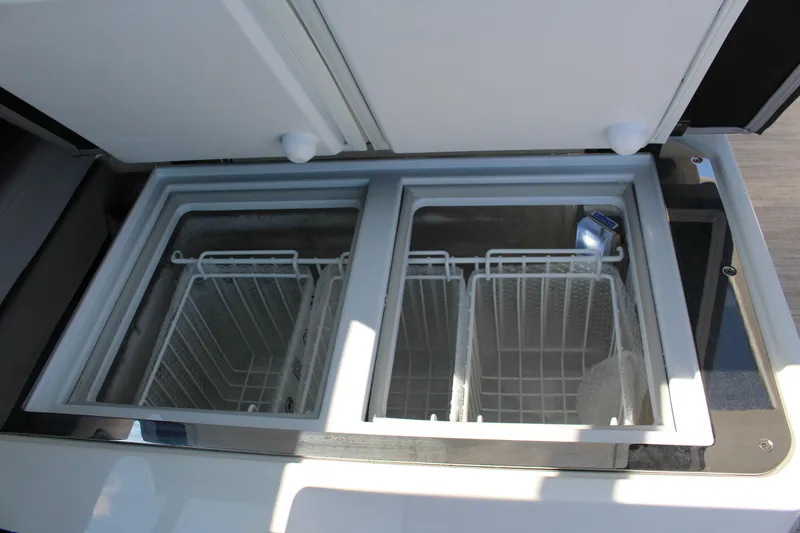 Slide: The Image of Built-in storage compartments in 2025 Cobalt R35 boat, featuring dual basket design. - 50