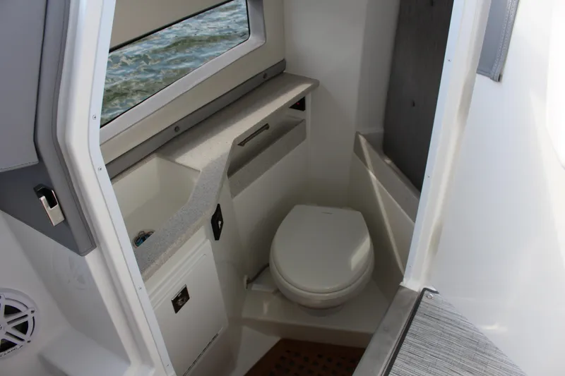 Slide: The Image of Interior of 2025 Cobalt R35 boat bathroom with toilet and sink. - 53