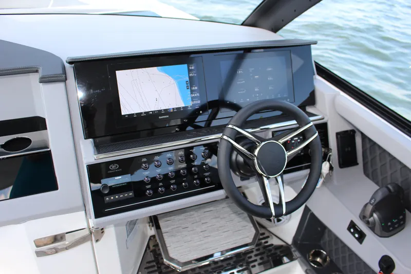 Slide: The Image of Modern Cobalt R35 2025 boat dashboard with touchscreen navigation and sleek steering wheel. - 54