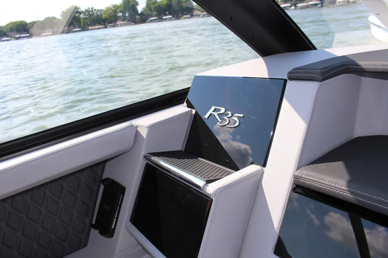 Slide: The Image of Interior of 2025 Cobalt R35 boat with lake view through window. - 60