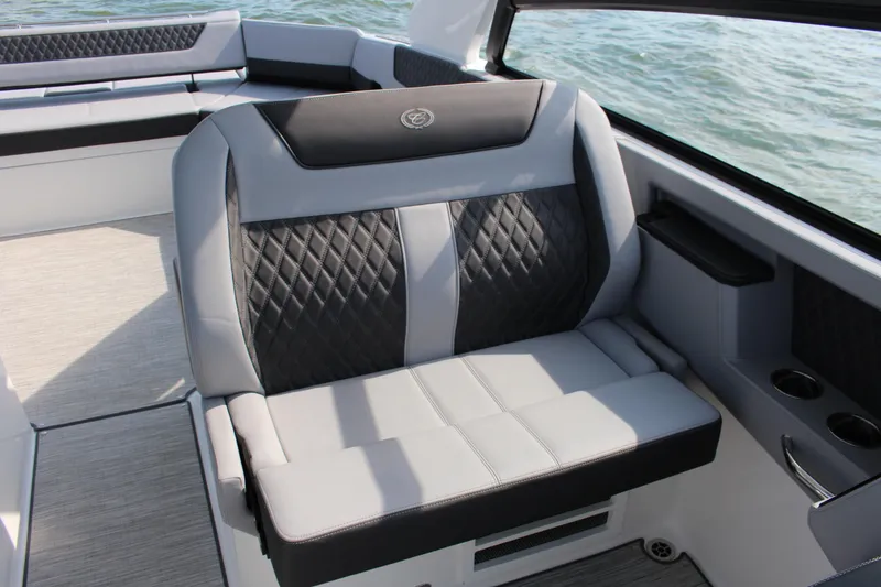 Slide: The Image of Luxurious seating on 2025 Cobalt R35 boat, featuring diamond-stitched upholstery and cup holders. - 62