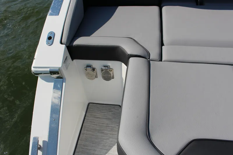 Slide: The Image of 2025 Cobalt R35 boat interior with gray seating and water backdrop. - 67