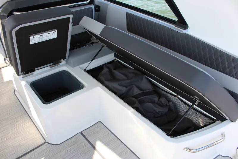 Slide: The Image of 2025 Cobalt R35 boat interior storage compartments with open lids, showcasing spacious design. - 73