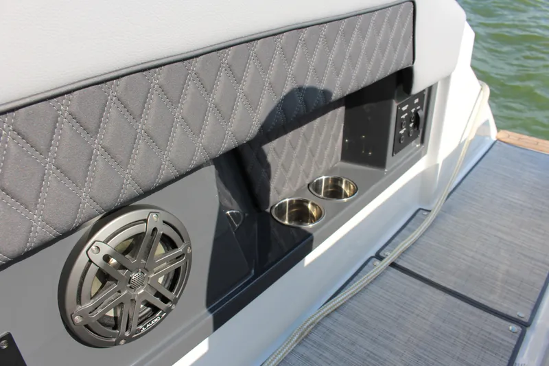 Slide: The Image of 2025 Cobalt R35 boat interior with speaker, cup holders, and quilted upholstery. - 75
