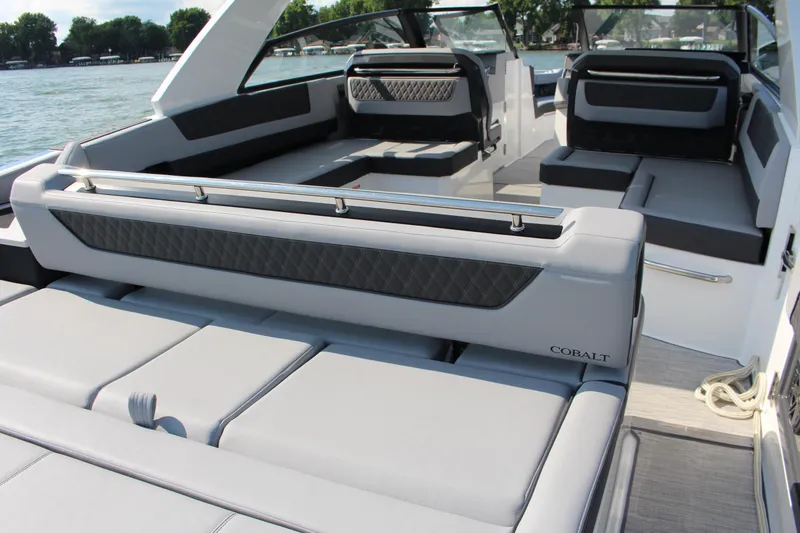 Slide: The Image of 2025 Cobalt R35 boat interior with luxurious seating on a serene lake. - 76