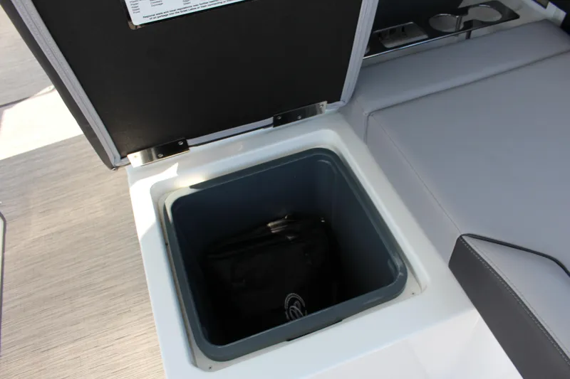 Slide: The Image of 2025 Cobalt R35 boat storage compartment with open lid and interior view. - 80