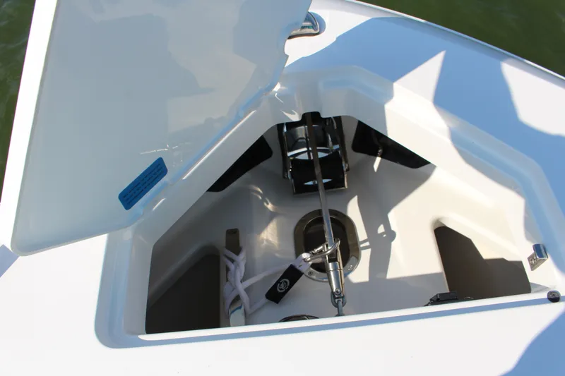 Slide: The Image of Open anchor compartment on 2025 Cobalt R35 boat, showcasing storage and equipment. - 82