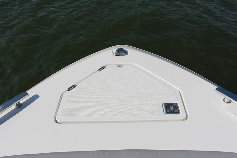 Slide: The Image of Bow of 2025 Cobalt R35 boat on water, featuring sleek design and storage hatch. - 83