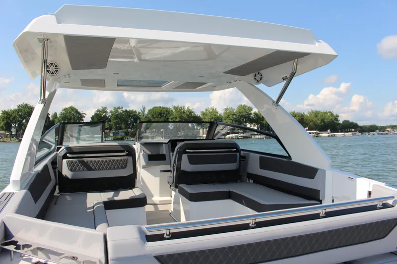 Slide: The Image of 2025 Cobalt R35 boat interior with spacious seating on a sunny day by the lake. - 84