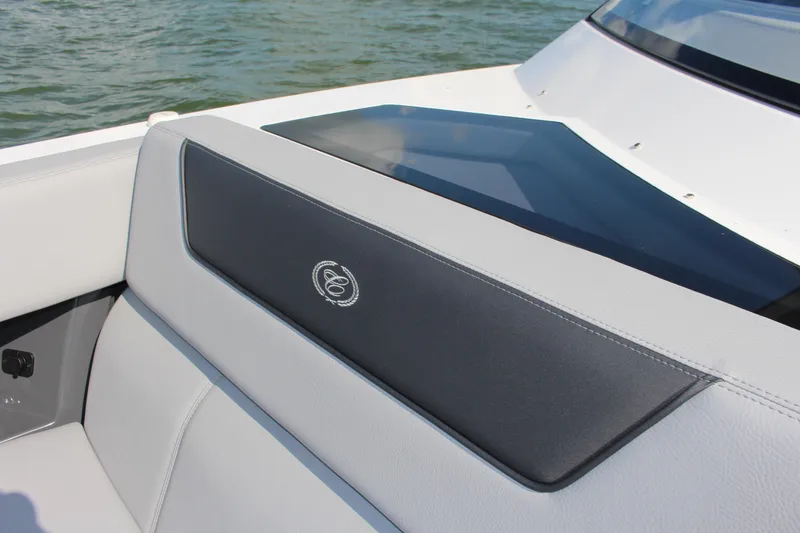Slide: The Image of 2025 Cobalt R35 boat interior with sleek white and black seating, on water. - 87