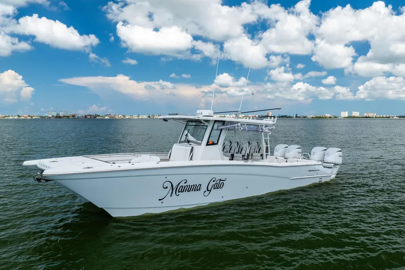 Slide: The Image of 2022 World Cat 400 CC-X boat on water under blue sky with clouds. - 1