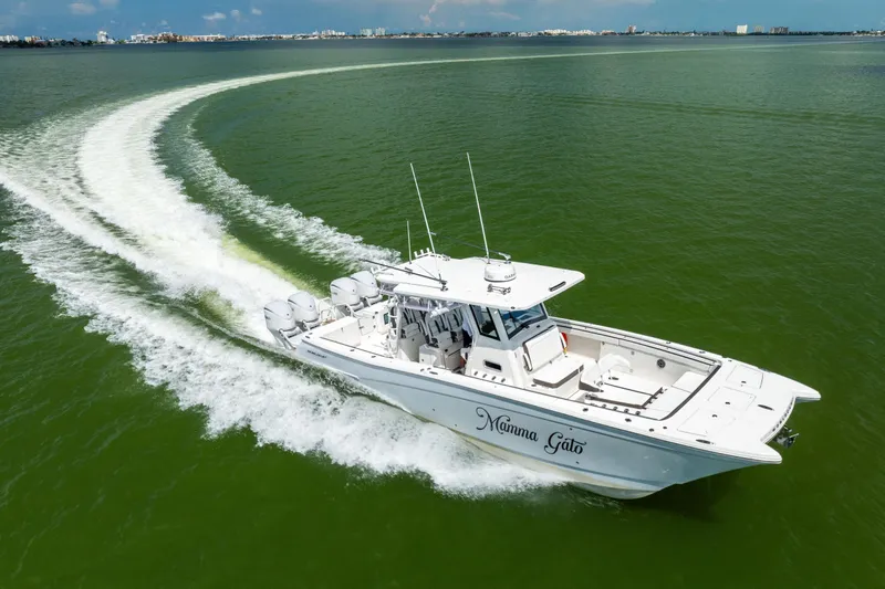 Slide: The Image of 2022 World Cat 400 CC-X boat cruising on green water, leaving a wake trail. - 14