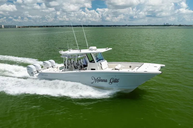 Slide: The Image of 2022 World Cat 400 CC-X boat cruising on green water under a cloudy sky. - 15