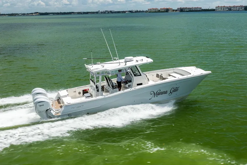 Slide: The Image of 2022 World Cat 400 CC-X boat cruising on green water with triple Yamaha engines. - 16