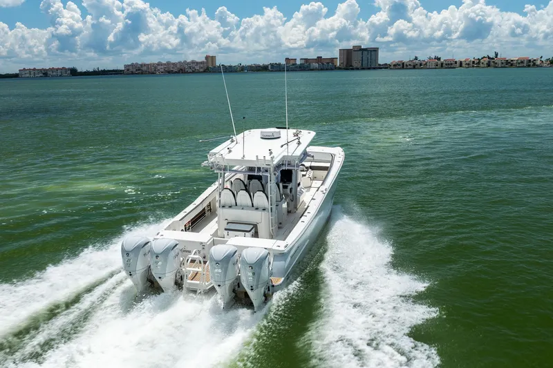 Slide: The Image of 2022 World Cat 400 CC-X cruising on open water, showcasing powerful engines and sleek design. - 17