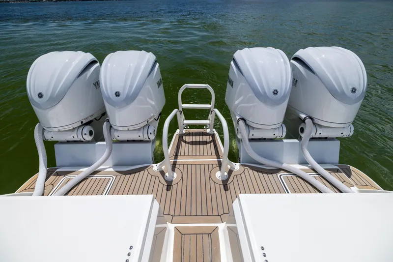 Slide: The Image of Four Yamaha outboard engines on a 2022 World Cat 400 CC-X boat, docked on water. - 22