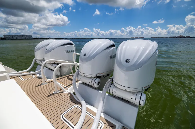 Slide: The Image of Three Yamaha outboard motors on a 2022 World Cat 400 CC-X boat, ocean backdrop. - 23