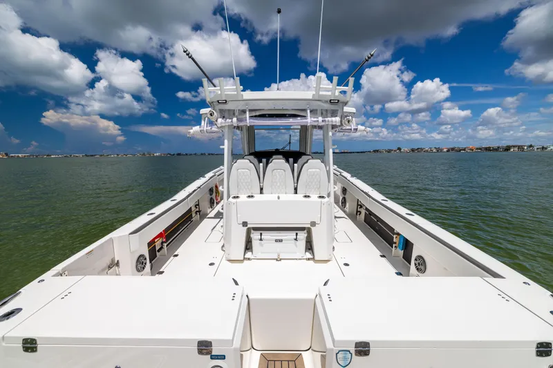 Slide: The Image of 2022 World Cat 400 CC-X boat on water under blue sky with clouds. - 24