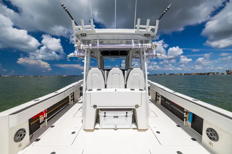 Slide: The Image of 2022 World Cat 400 CC-X boat on water under blue sky with clouds. - 25