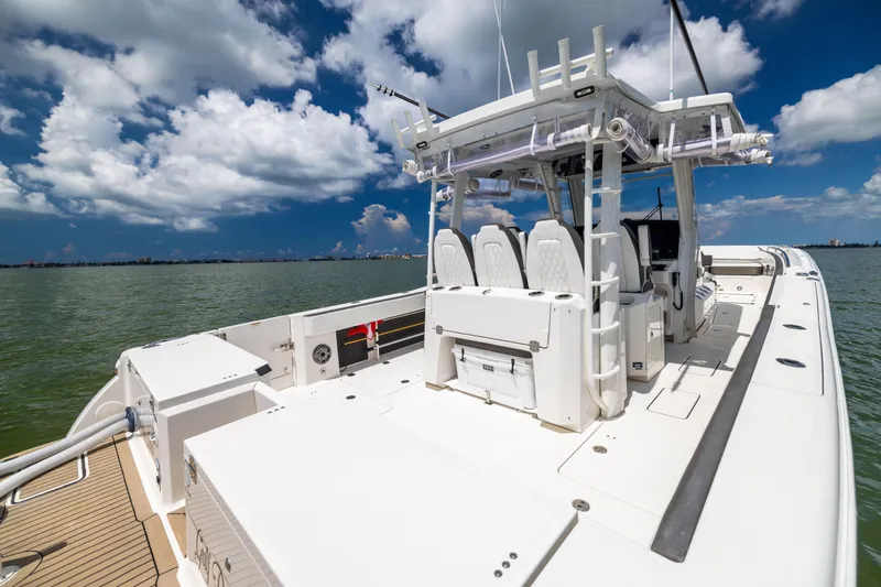 Slide: The Image of 2022 World Cat 400 CC-X boat on water under a partly cloudy sky. - 26