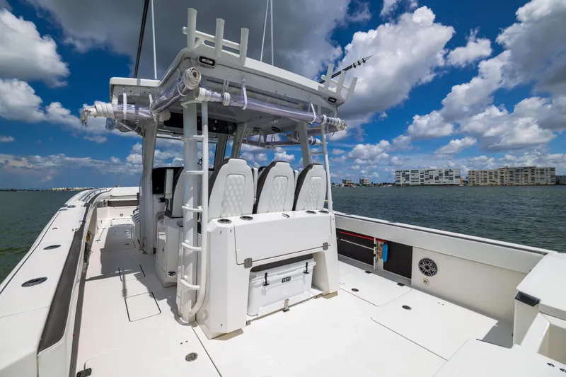 Slide: The Image of 2022 World Cat 400 CC-X boat on water under blue sky with clouds. - 29