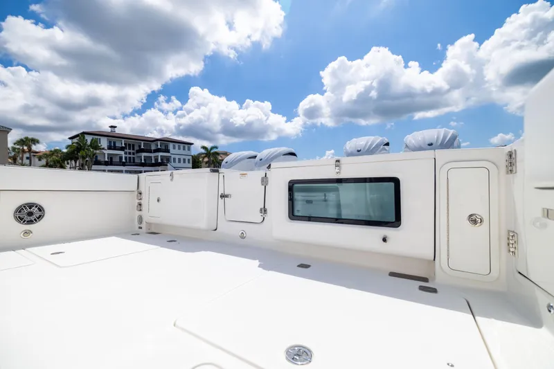 Slide: The Image of 2022 World Cat 400 CC-X boat deck under a bright blue sky with clouds. - 30