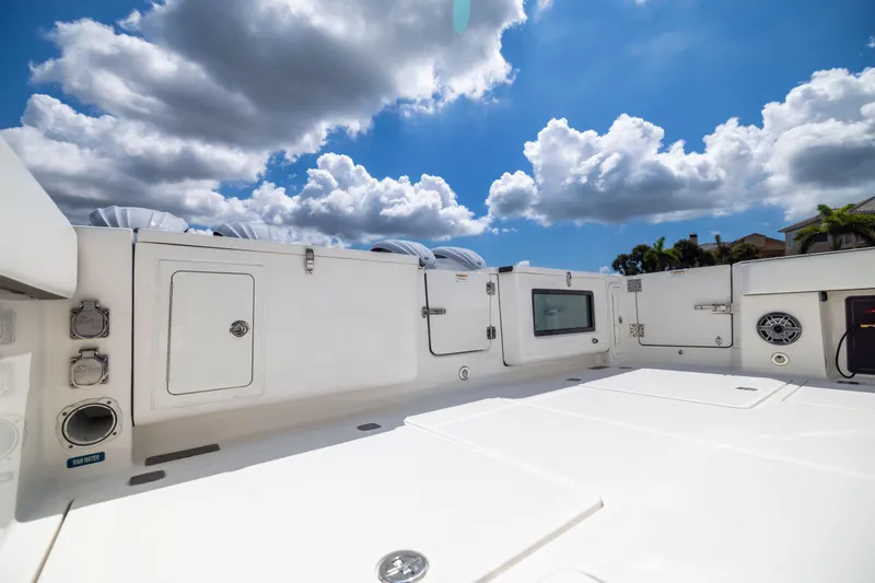 Slide: The Image of 2022 World Cat 400 CC-X boat deck under a bright blue sky with clouds. - 31