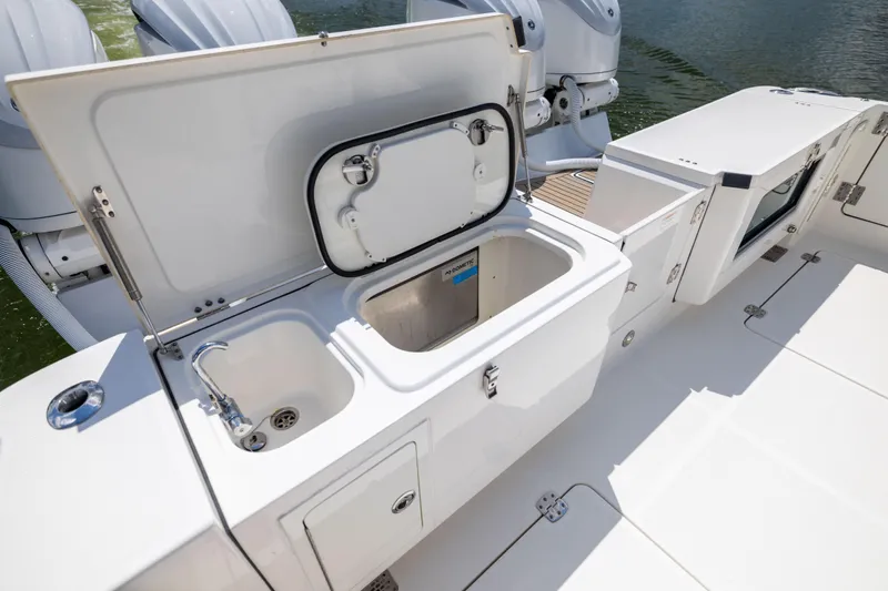 Slide: The Image of 2022 World Cat 400 CC-X boat with open storage compartments and sink on deck. - 34