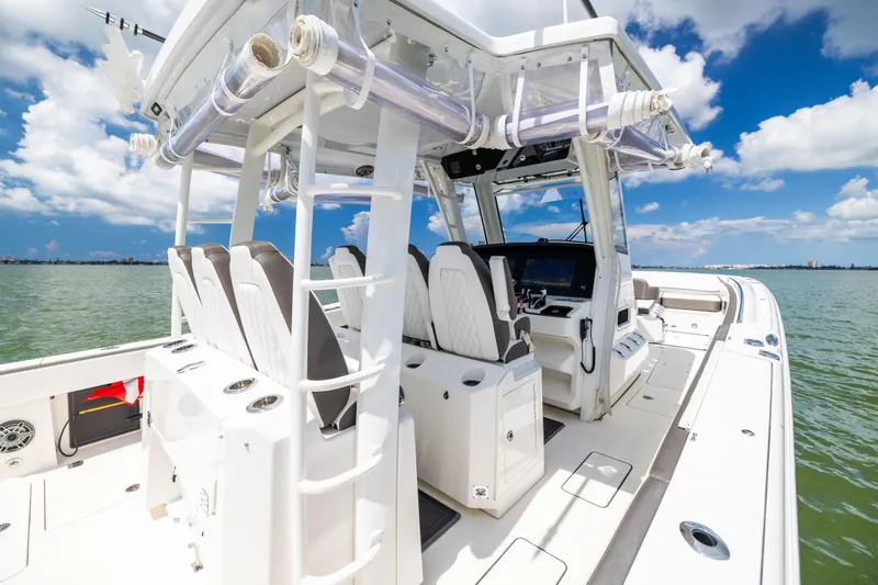 Slide: The Image of 2022 World Cat 400 CC-X boat interior with helm, seats, and ocean view. - 36