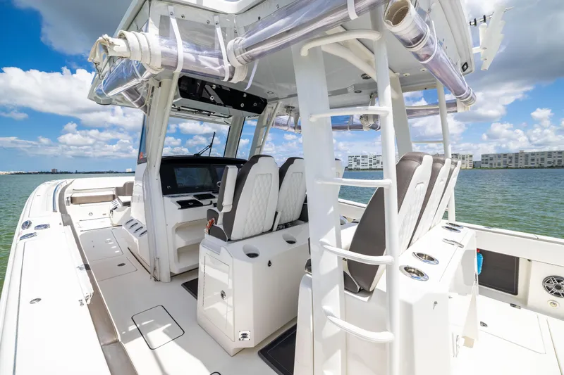 Slide: The Image of 2022 World Cat 400 CC-X boat interior with helm, seats, and ocean view. - 37