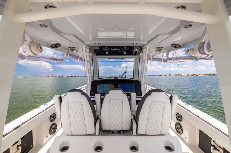 Slide: The Image of Interior view of 2022 World Cat 400 CC-X boat with luxurious seating and ocean backdrop. - 38
