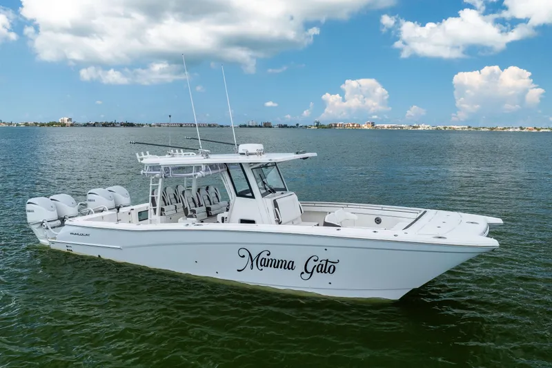 Slide: The Image of 2022 World Cat 400 CC-X boat on water, clear sky background. - 4