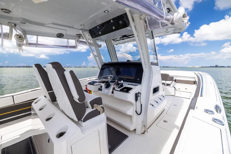 Slide: The Image of 2022 World Cat 400 CC-X boat interior with helm, seats, and ocean view. - 40