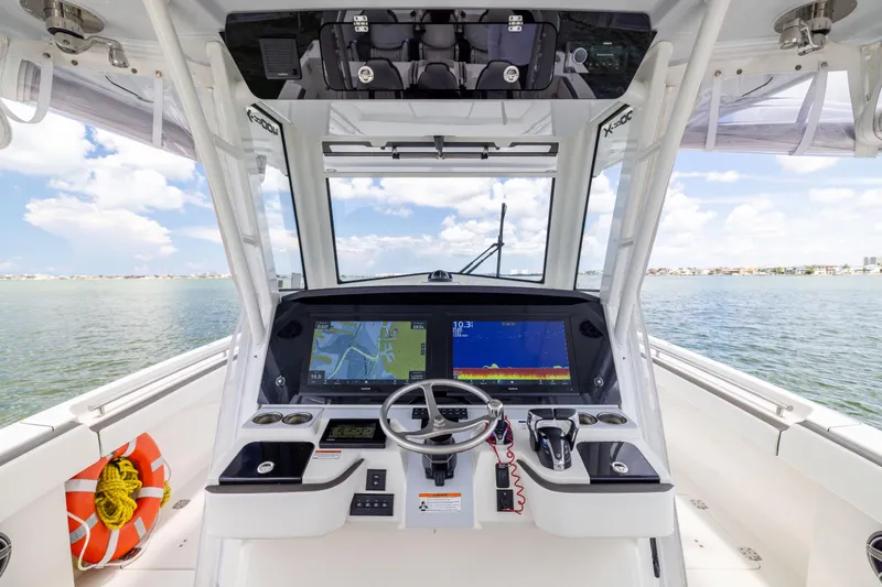 Slide: The Image of Interior view of 2022 World Cat 400 CC-X boat cockpit with navigation screens. - 42