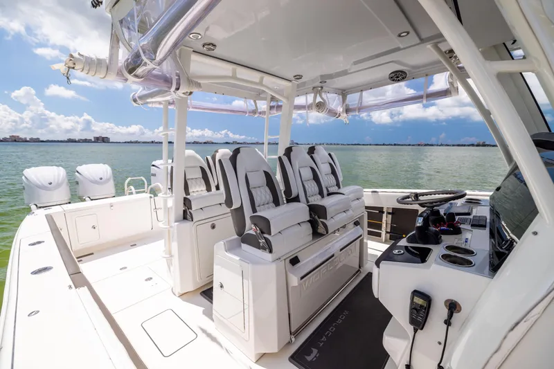 Slide: The Image of 2022 World Cat 400 CC-X boat interior with luxurious seating and modern controls on open water. - 44
