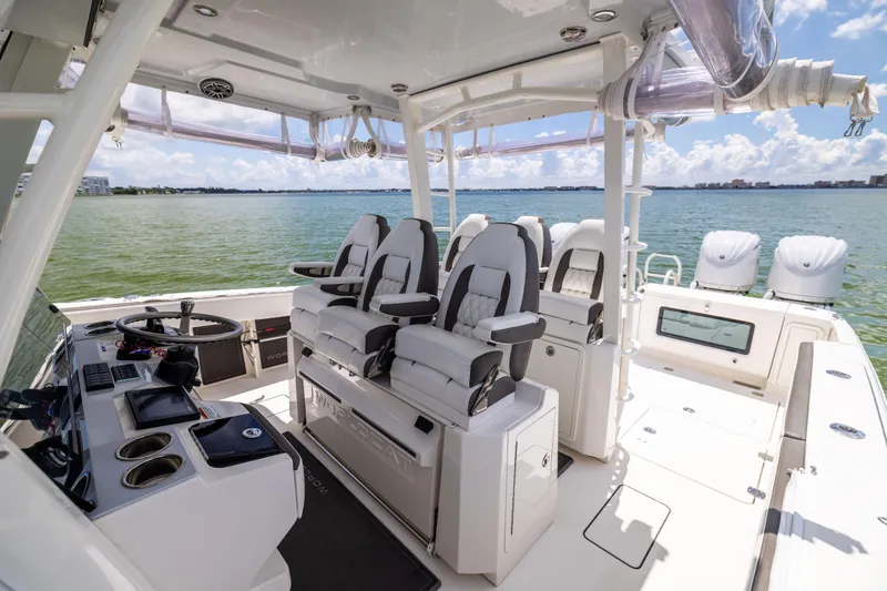 Slide: The Image of 2022 World Cat 400 CC-X boat interior with helm, seating, and ocean view. - 46