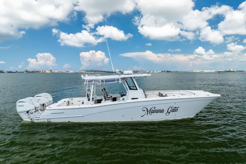 Slide: The Image of 2022 World Cat 400 CC-X boat on water, clear sky background. - 5