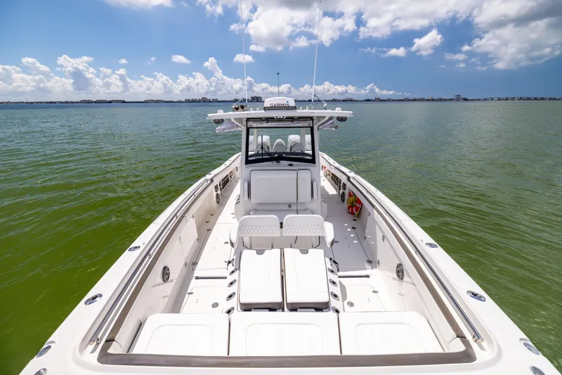 Slide: The Image of 2022 World Cat 400 CC-X boat on calm water under a partly cloudy sky. - 50