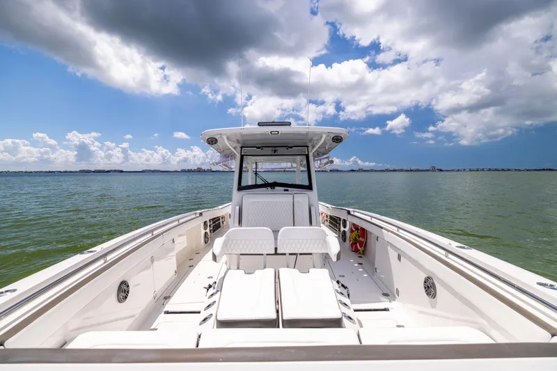 Slide: The Image of 2022 World Cat 400 CC-X boat on open water under a partly cloudy sky. - 51