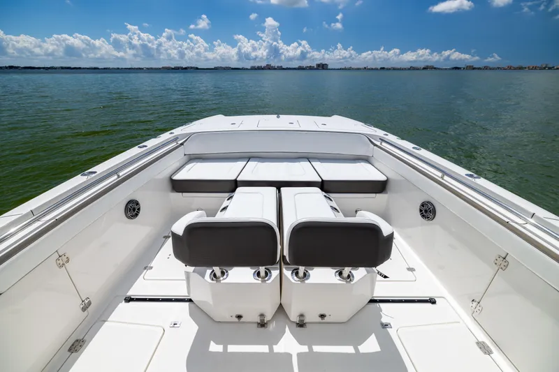 Slide: The Image of 2022 World Cat 400 CC-X boat interior with seating, overlooking calm waters and blue sky. - 52