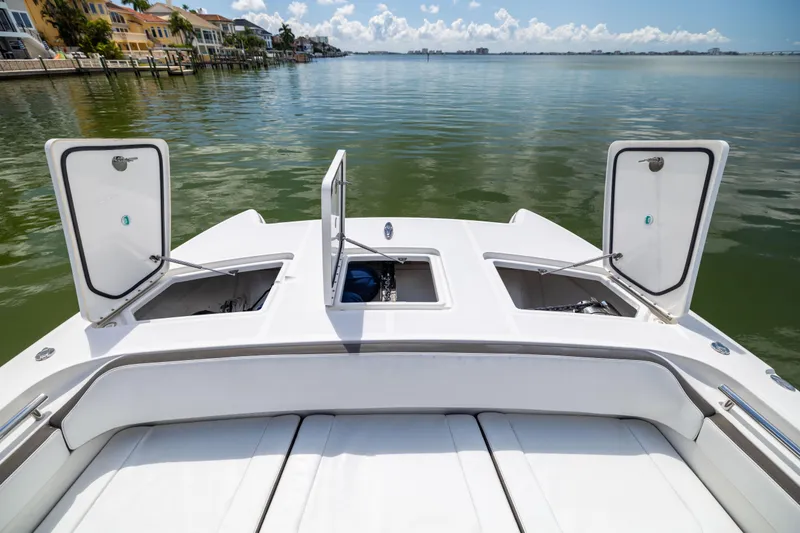 Slide: The Image of 2022 World Cat 400 CC-X boat with open storage compartments on calm water. - 55