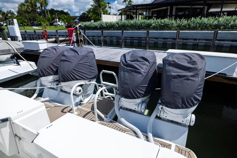 Slide: The Image of Four covered outboard motors on a 2022 World Cat 400 CC-X boat docked at a marina. - 62
