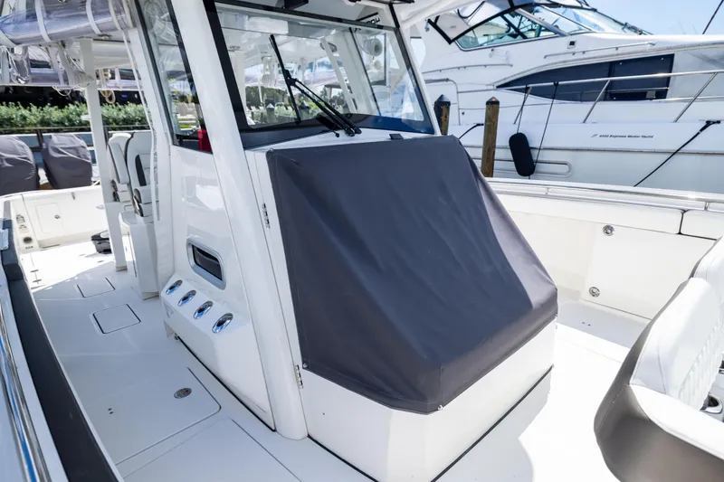 Slide: The Image of 2022 World Cat 400 CC-X boat interior with covered console and seating area. - 63