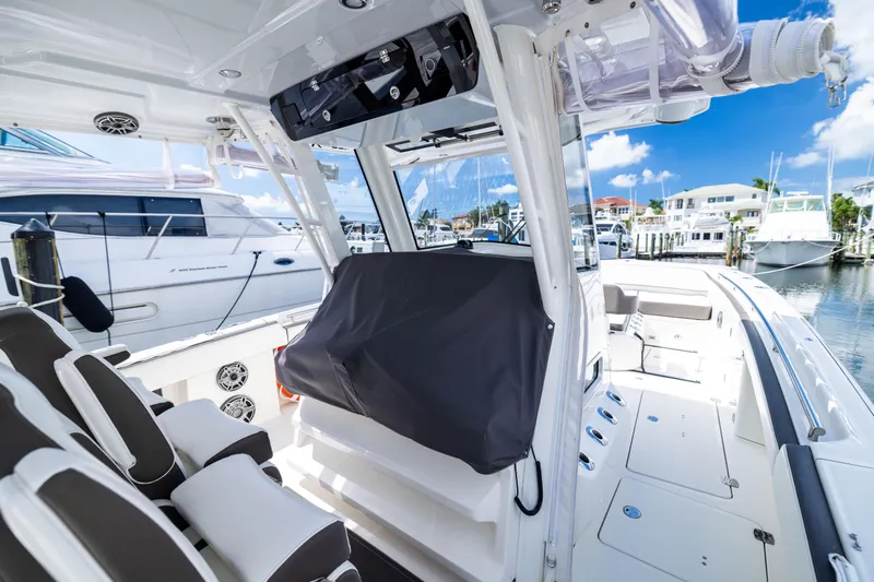 Slide: The Image of 2022 World Cat 400 CC-X boat interior at marina, featuring sleek seating and modern design. - 64