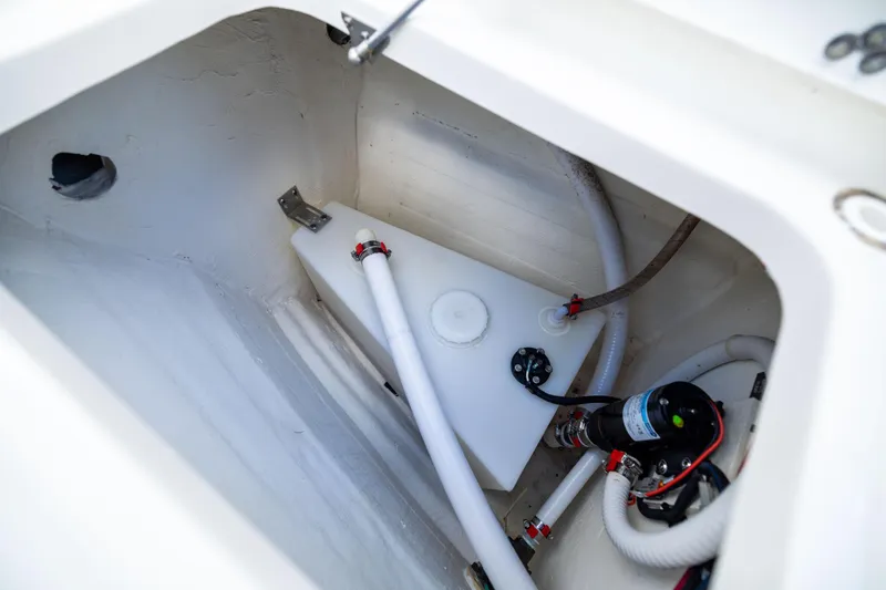 Slide: The Image of 2022 World Cat 400 CC-X boat compartment with water tank and pump system. - 65