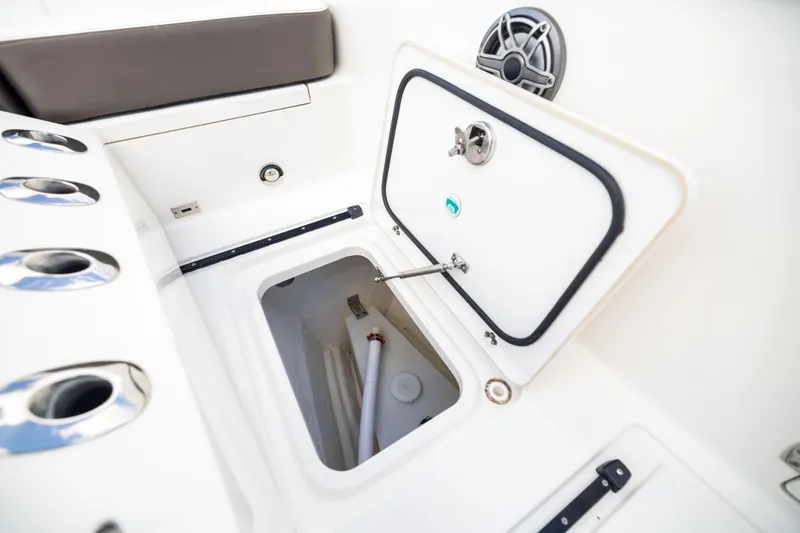 Slide: The Image of 2022 World Cat 400 CC-X boat storage compartment with open hatch and rod holders. - 66