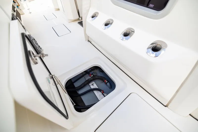 Slide: The Image of 2022 World Cat 400 CC-X boat interior with open hatch and visible storage compartment. - 68
