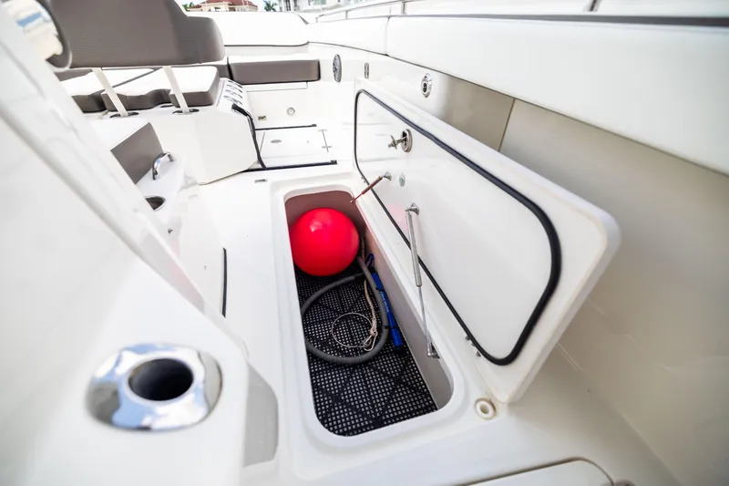 Slide: The Image of Storage compartment on 2022 World Cat 400 CC-X boat with red buoy and rope. - 69