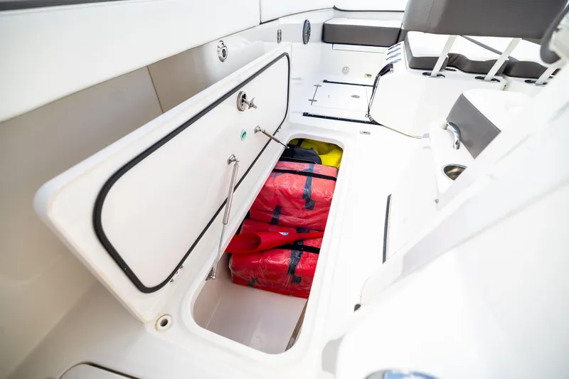 Slide: The Image of 2022 World Cat 400 CC-X boat storage compartment with red life jackets. - 70