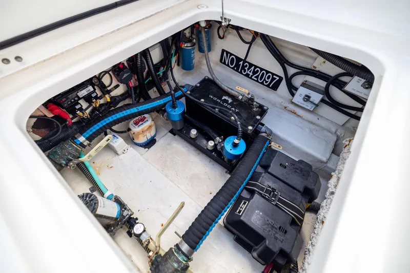 Slide: The Image of Engine compartment of 2022 World Cat 400 CC-X boat, showcasing wiring and components. - 81